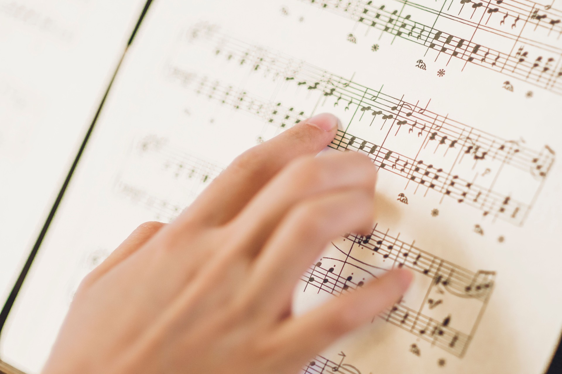 hands of a person reading musical scores